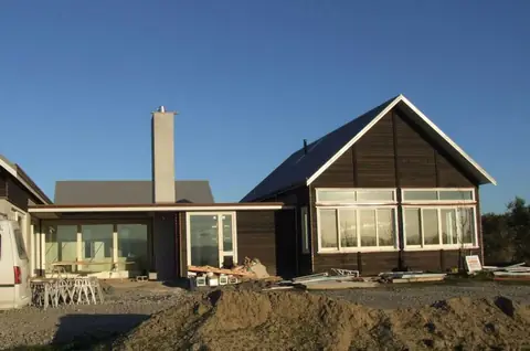 Gabled new home with dark timber cladding nearing completion